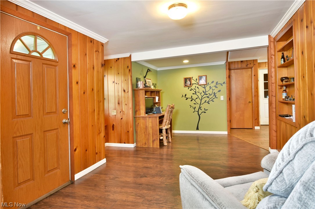 1711 Salt Springs Road Mineral Ridge, OH 44440 - Photo 7 of 35 Foyer entrance with wood walls, ornamental molding, and hardwood floors