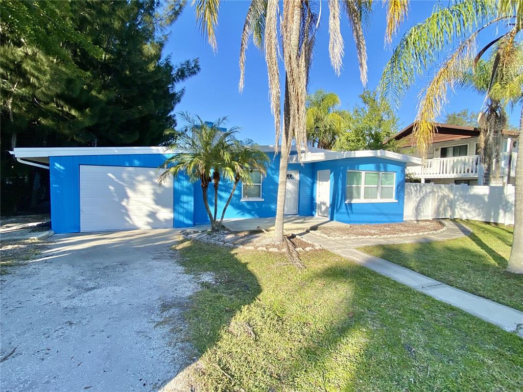 120 Grace Street Crystal Beach, FL 34681 - Photo 11 of 12 a view of a house with a yard and garage