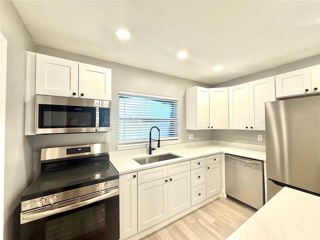 120 Grace Street Crystal Beach, FL 34681 - Photo 6 of 12 a kitchen with appliances cabinets and a sink