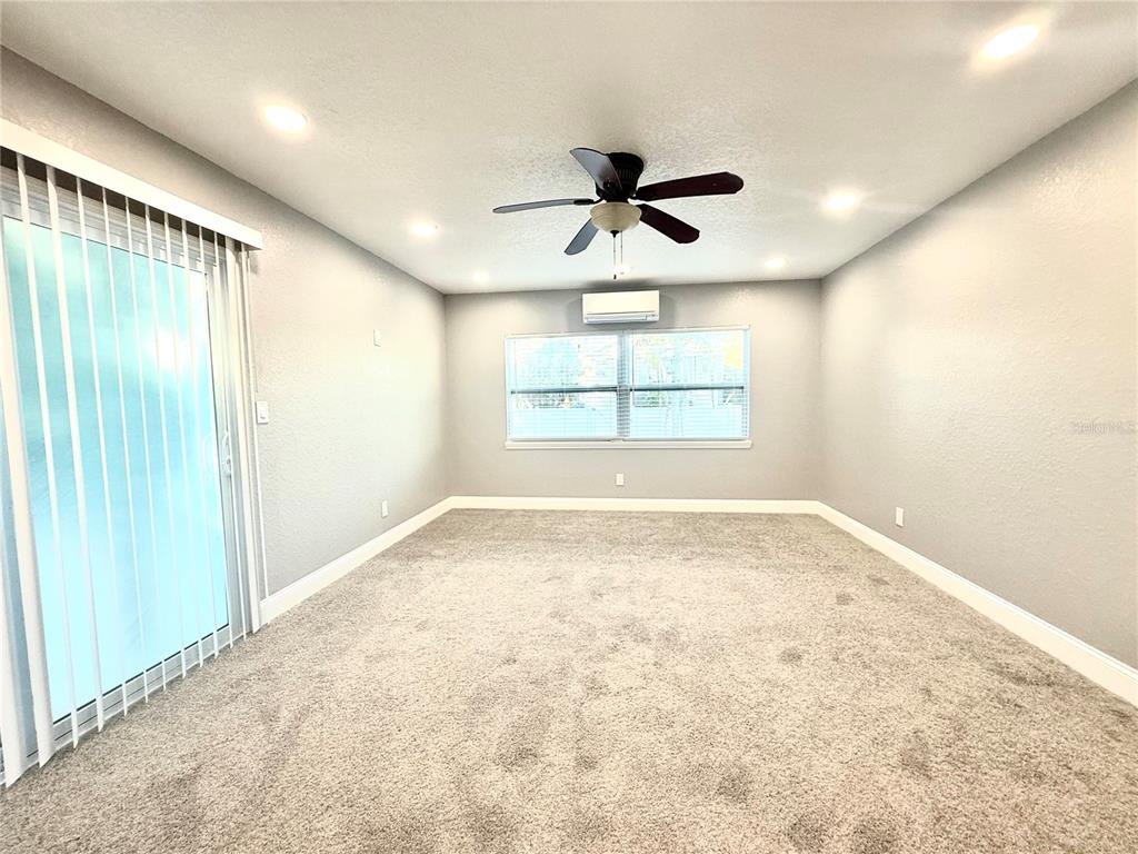 120 Grace Street Crystal Beach, FL 34681 - Photo 7 of 12 an empty room with windows and ceiling fan view