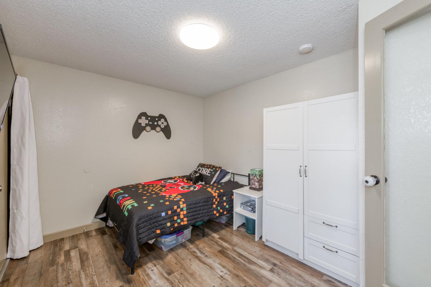 1390 Filbert Avenue Clovis, CA 93611 - Photo 17 of 36 a bedroom with a bed and a dresser