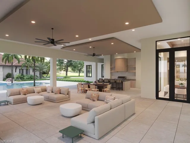 a living room with patio furniture and a large window