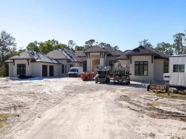 a view of a house with a yard and sitting area