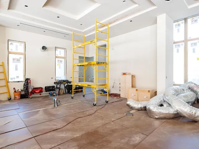 a living room with furniture and large windows