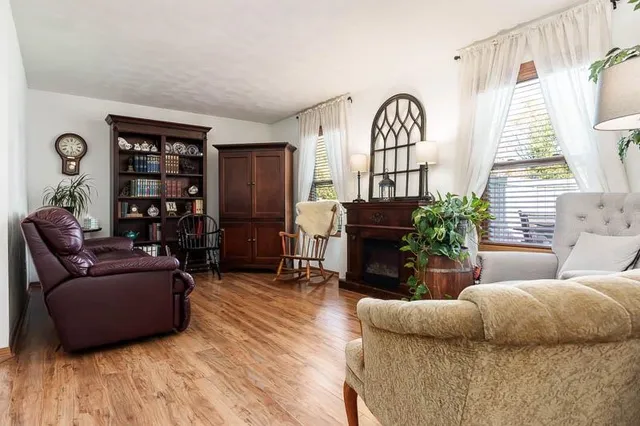 a living room with furniture and wooden floor