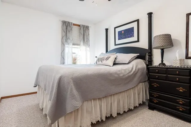 a bed sitting in a bedroom next to a window