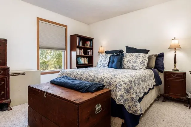 a bedroom with a bed and a table