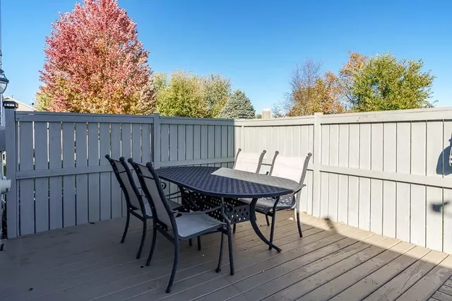 a view of a patio with wooden fence