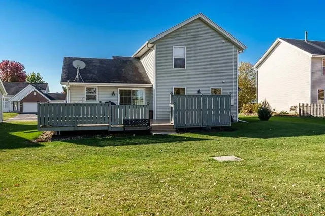 a view of a house with a yard and deck
