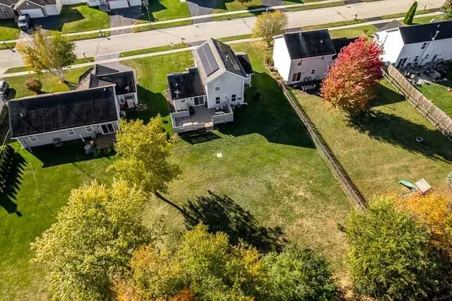 an aerial view of a house with a garden lake view