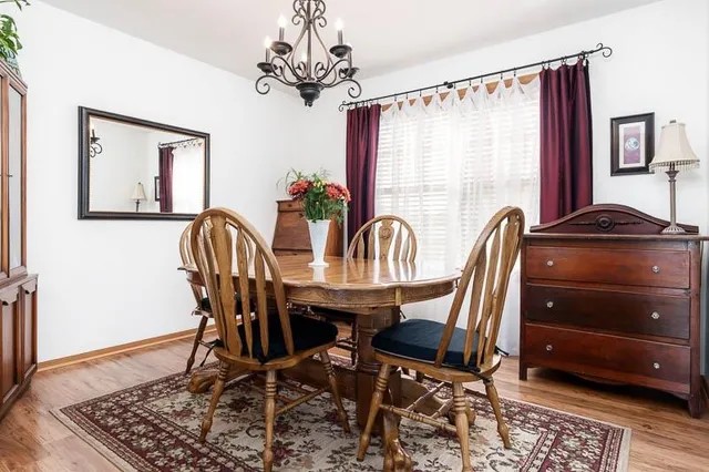 a view of a dining room with furniture and window