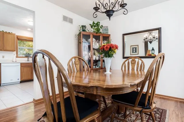 a view of a dining room with furniture and a chandelier