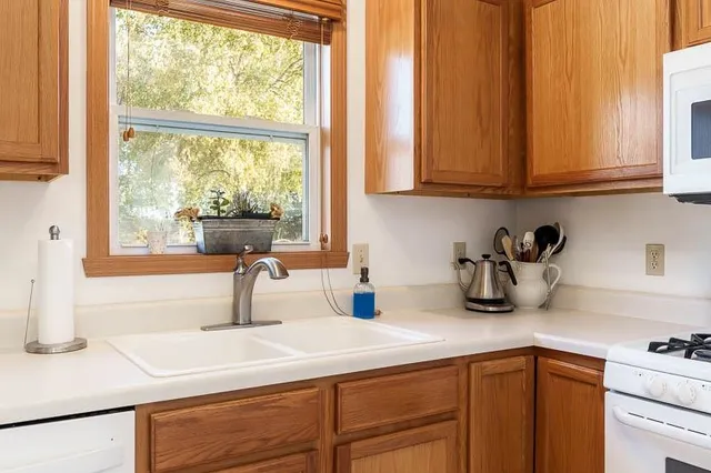 a kitchen with appliances cabinets and a sink