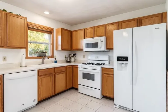 a kitchen with stainless steel appliances a refrigerator sink and microwave