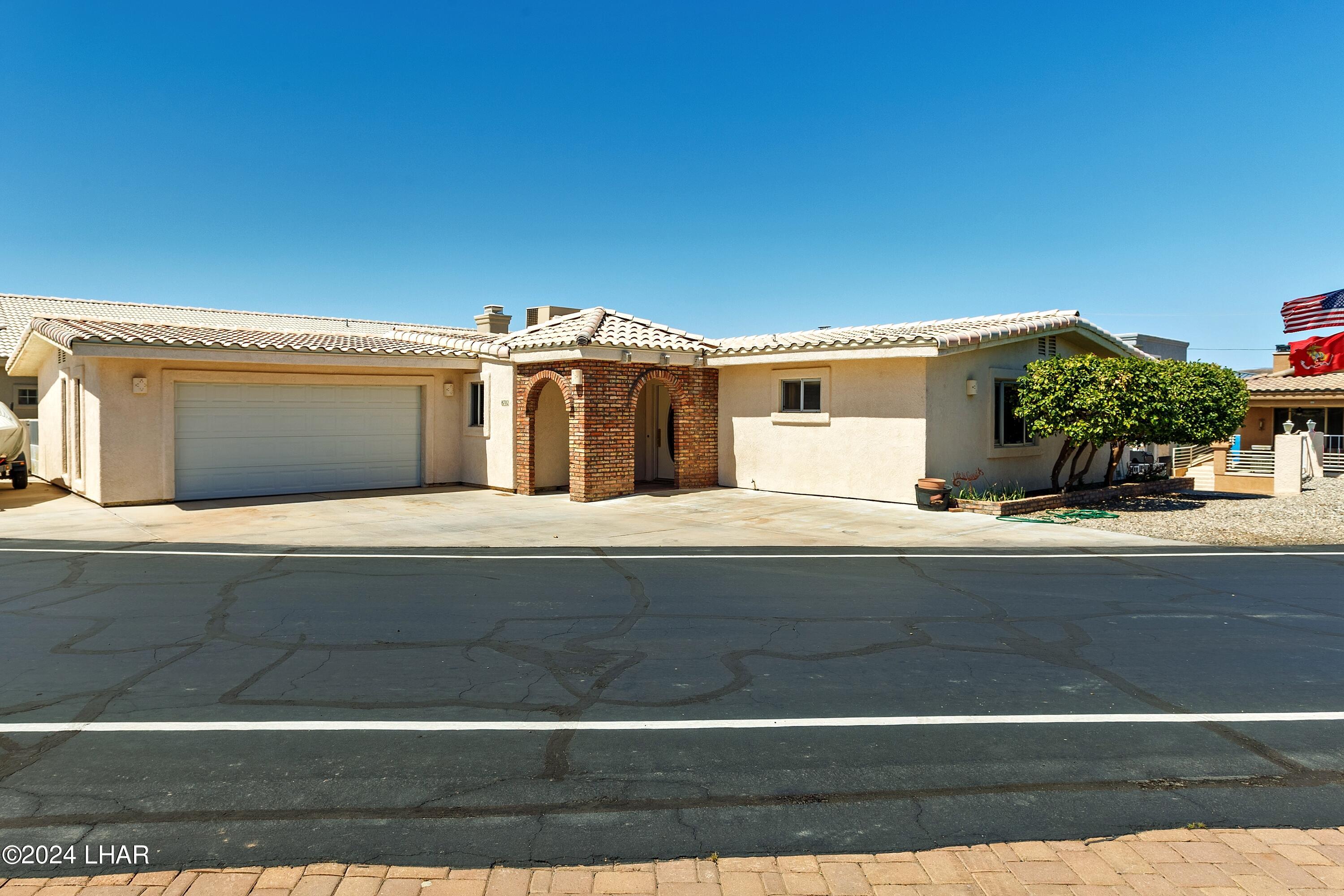 8702 Papago Loop Parker, AZ 85344 - Photo 11 of 36 a front view of a house with a garage