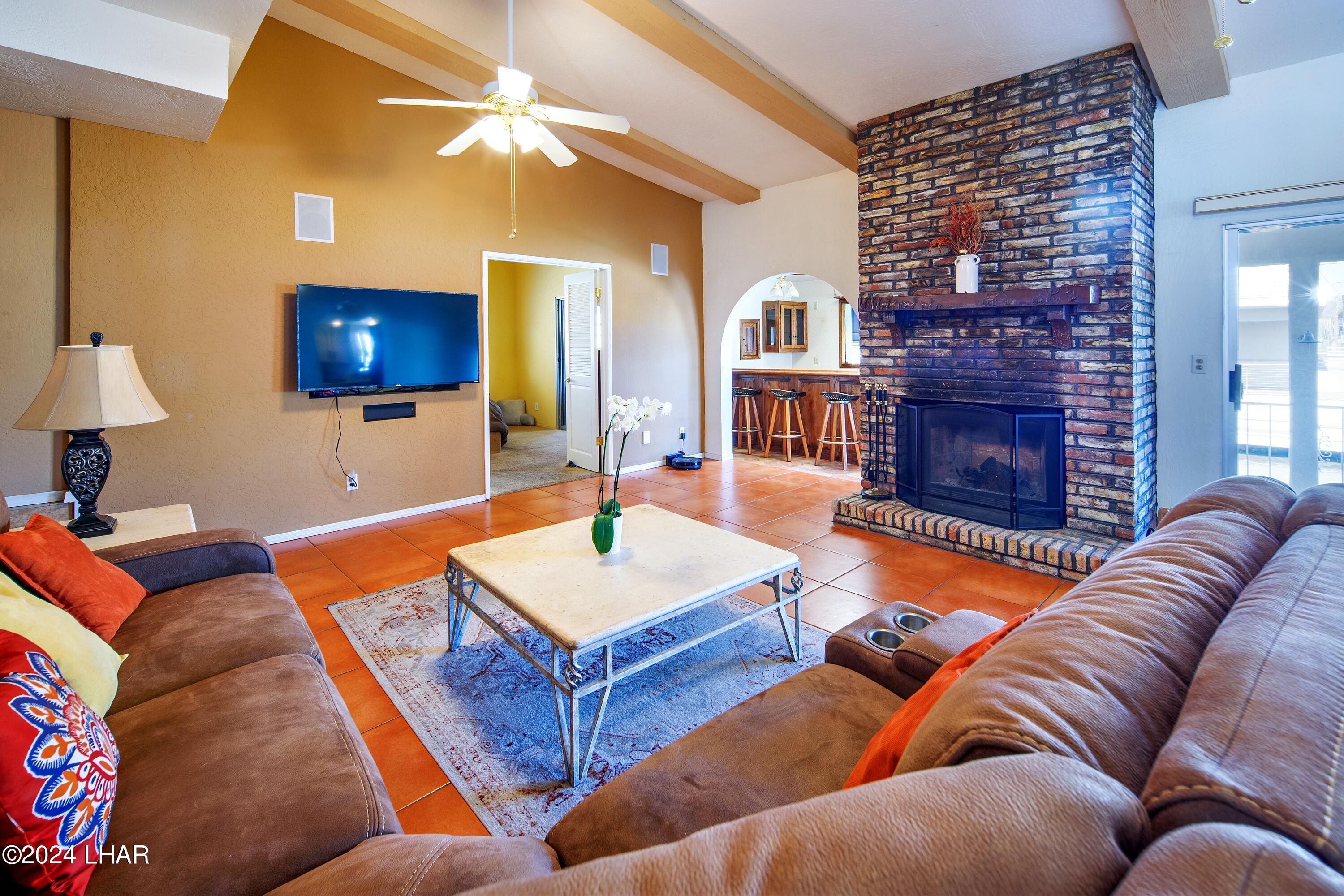 8702 Papago Loop Parker, AZ 85344 - Photo 20 of 36 a living room with furniture a flat screen tv and a lamp