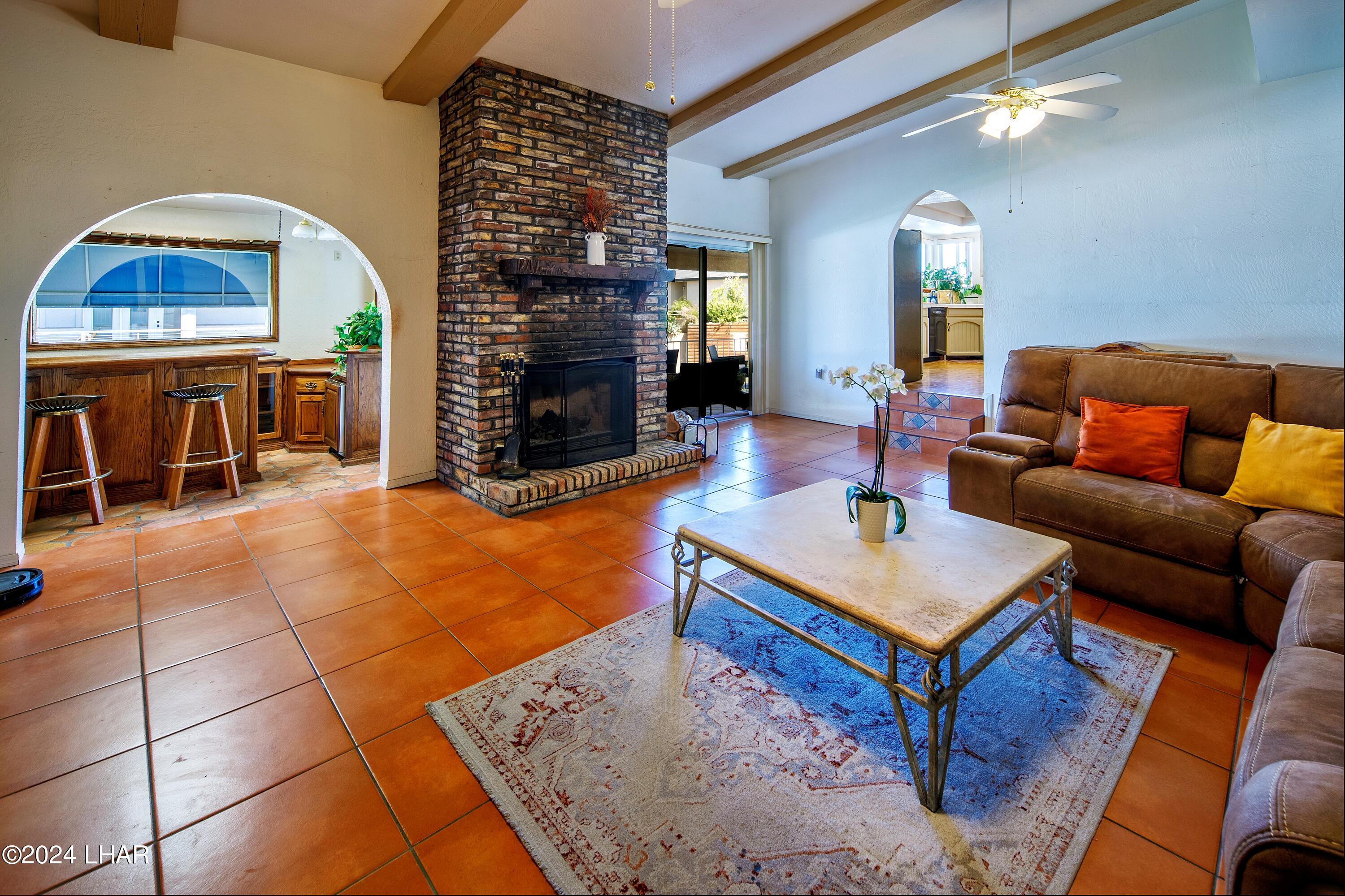 8702 Papago Loop Parker, AZ 85344 - Photo 22 of 36 a living room with furniture a rug and a fireplace