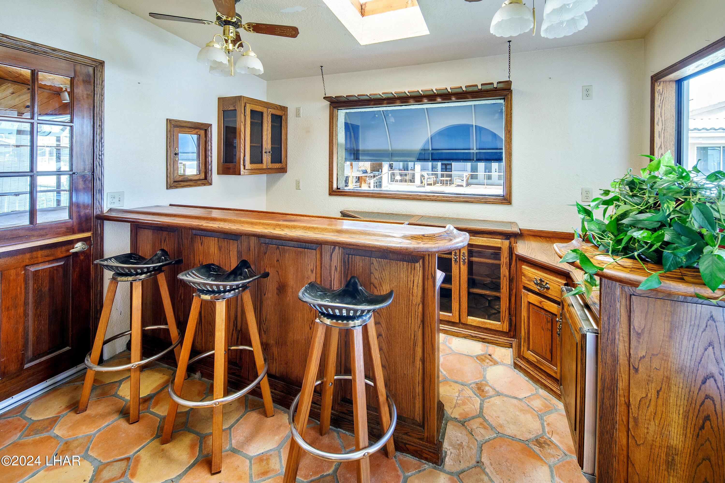 8702 Papago Loop Parker, AZ 85344 - Photo 23 of 36 a dining table chair with granite countertop a stove and cabinets