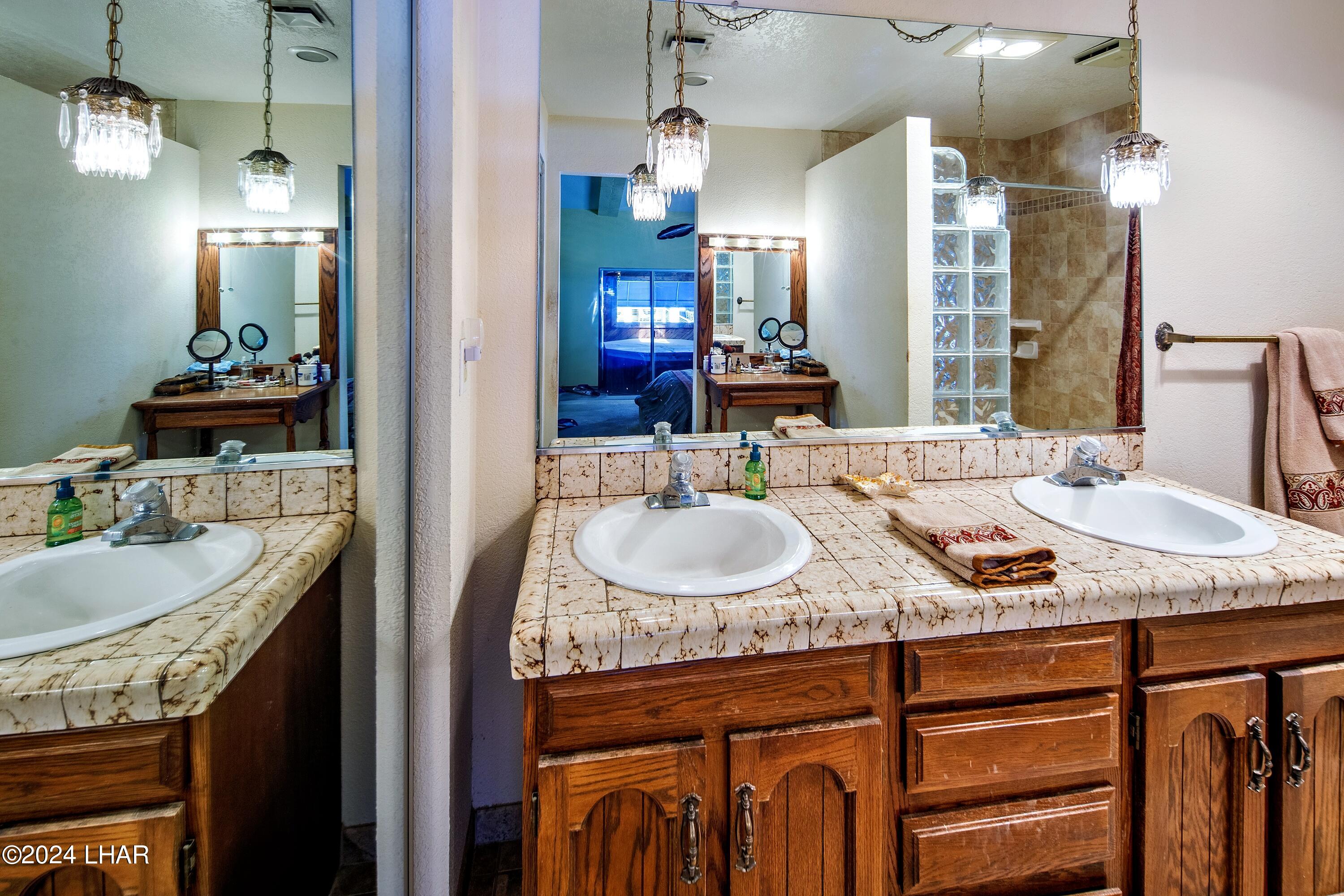 8702 Papago Loop Parker, AZ 85344 - Photo 27 of 36 a bathroom with a granite countertop sink and a mirror