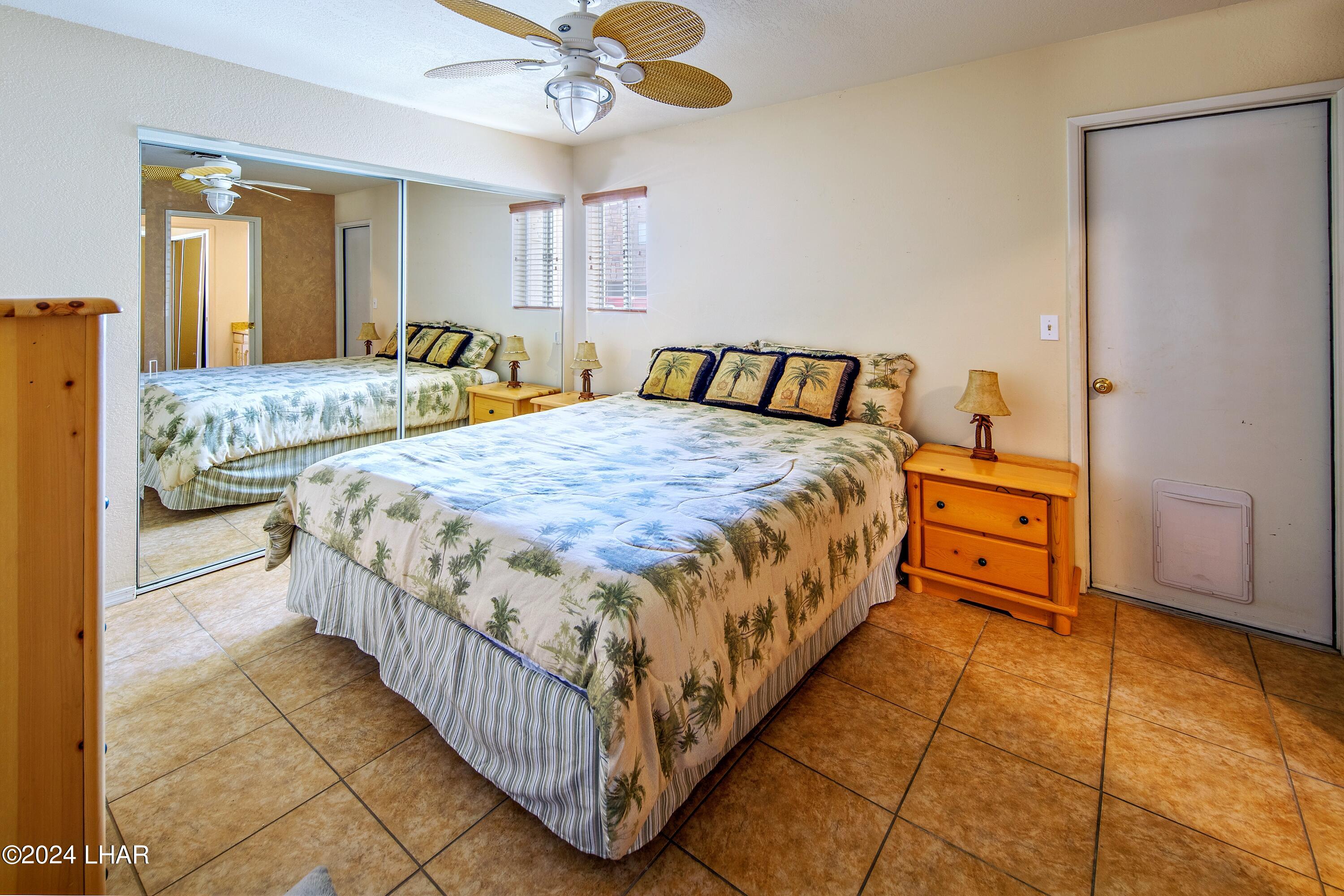8702 Papago Loop Parker, AZ 85344 - Photo 29 of 36 a bedroom with a bed and a chandelier