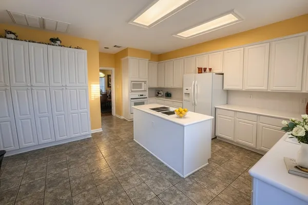 a kitchen with a refrigerator and a stove