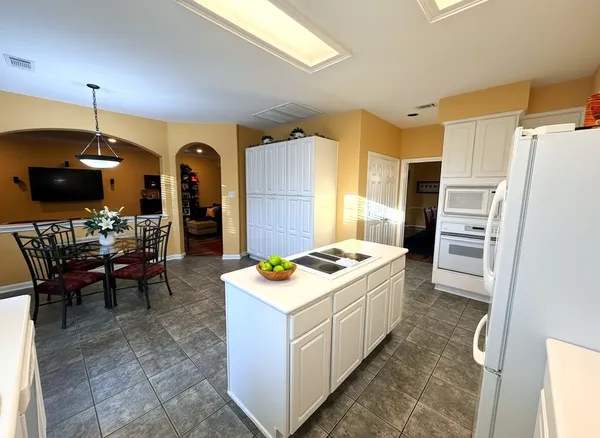 a kitchen that has a table and chairs in it
