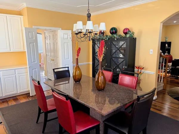 a view of a dining room with furniture and chandelier