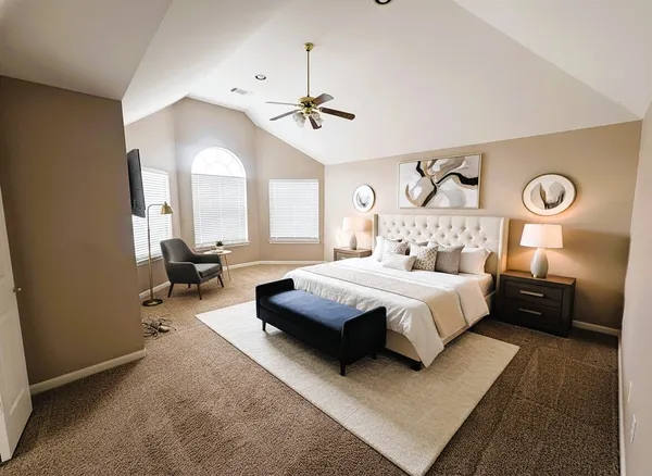 a bedroom with a bed couch and window