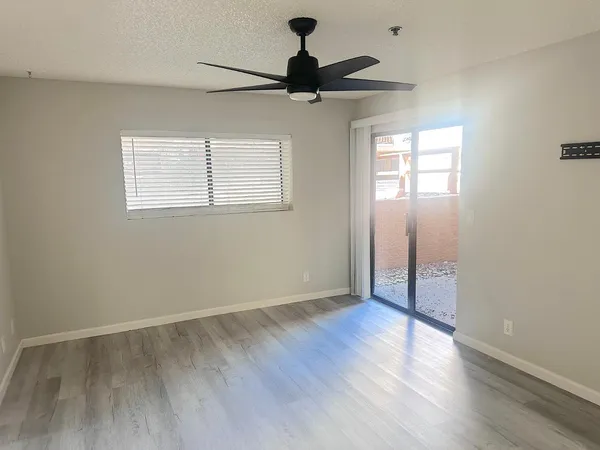 a view of empty room with wooden floor