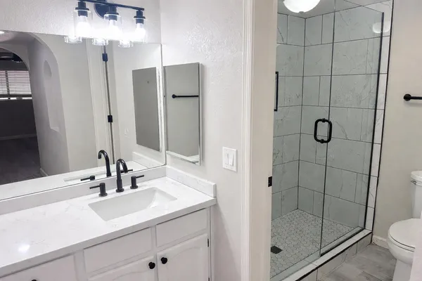 a bathroom with a shower sink and toilet