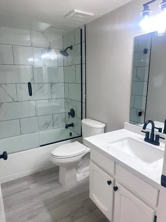 a bathroom with a sink toilet and shower