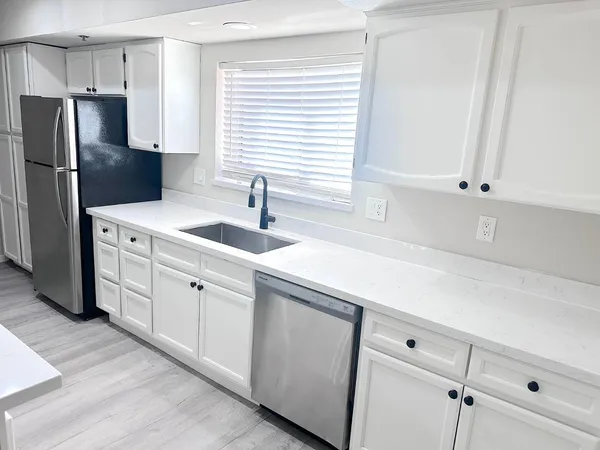 a kitchen with appliances cabinets and a sink
