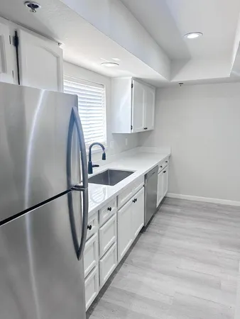 a kitchen with stainless steel appliances a refrigerator sink and cabinets