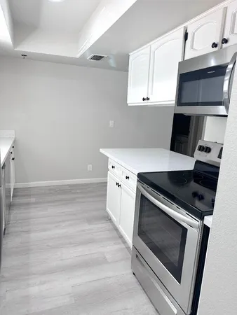 a kitchen with a stove and a microwave