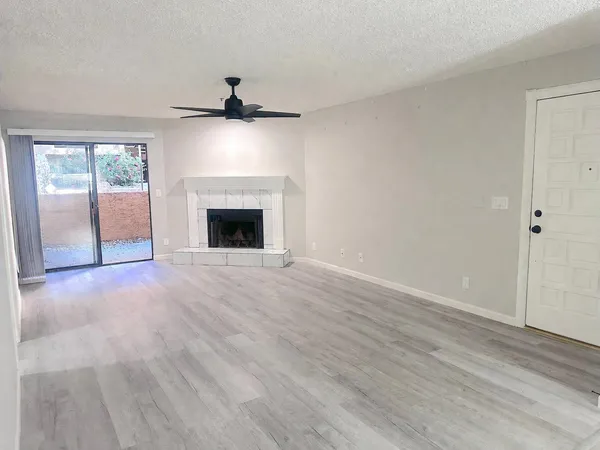 wooden floor fireplace and natural light in room