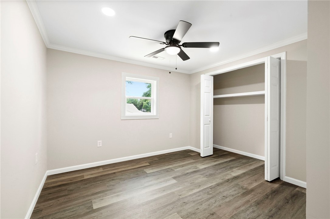 418 Old River Road Pelzer, SC 29669 - Photo 20 of 29 Laminate flooring and a functional ceiling fan define this comfortable bedroom space.