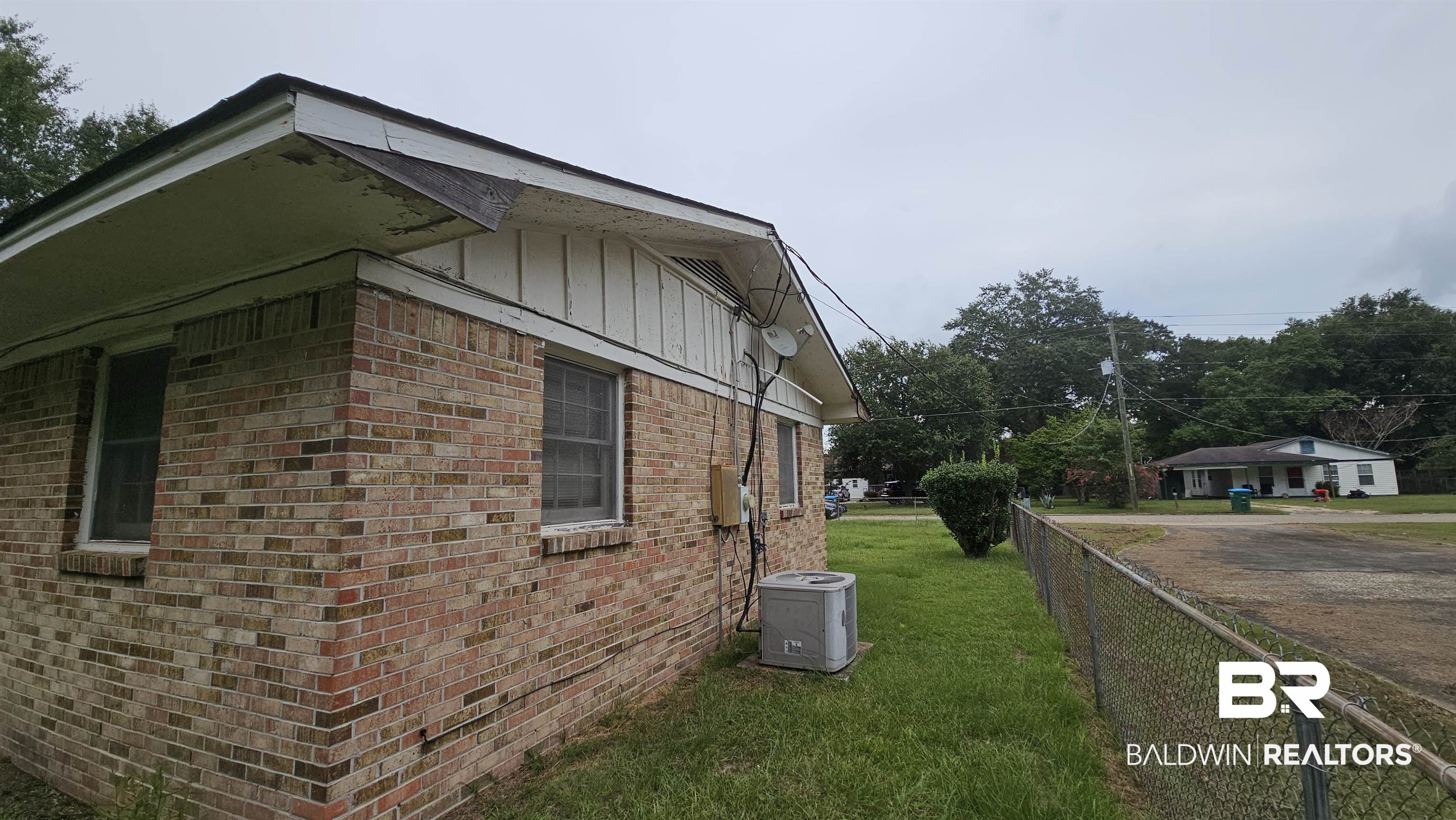 216 6th Avenue Atmore, AL 36502 - Photo 29 of 34 View of home's exterior featuring a lawn and central AC unit