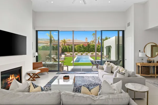 a living room with fireplace furniture and a flat screen tv