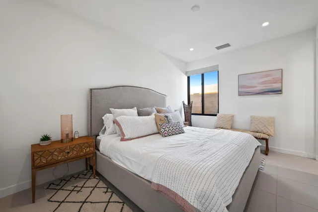 a bedroom with a bed and a couch