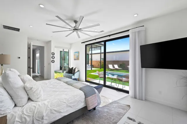 a bed room with a bed and a television