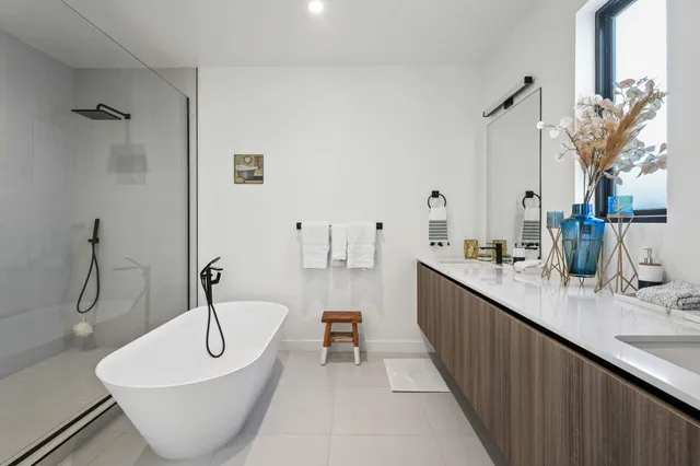 a bathroom with a double vanity sink and a bathtub