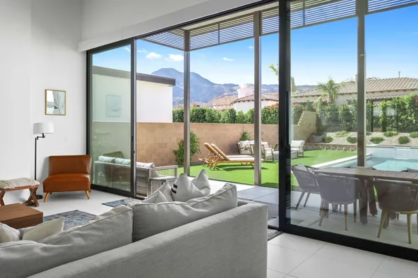 a living room with couch and a floor to ceiling window