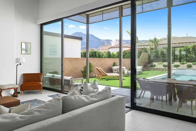 a living room with couch and a floor to ceiling window