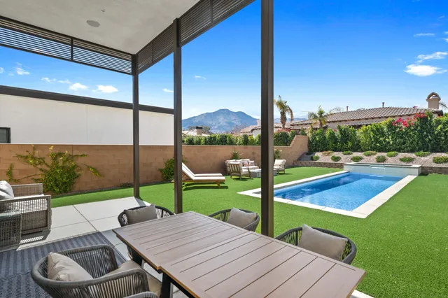 a view of a patio with chairs and a table