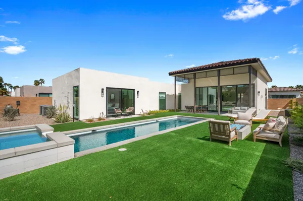a view of a house with a yard porch and sitting area