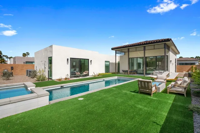 a view of a house with a yard porch and sitting area