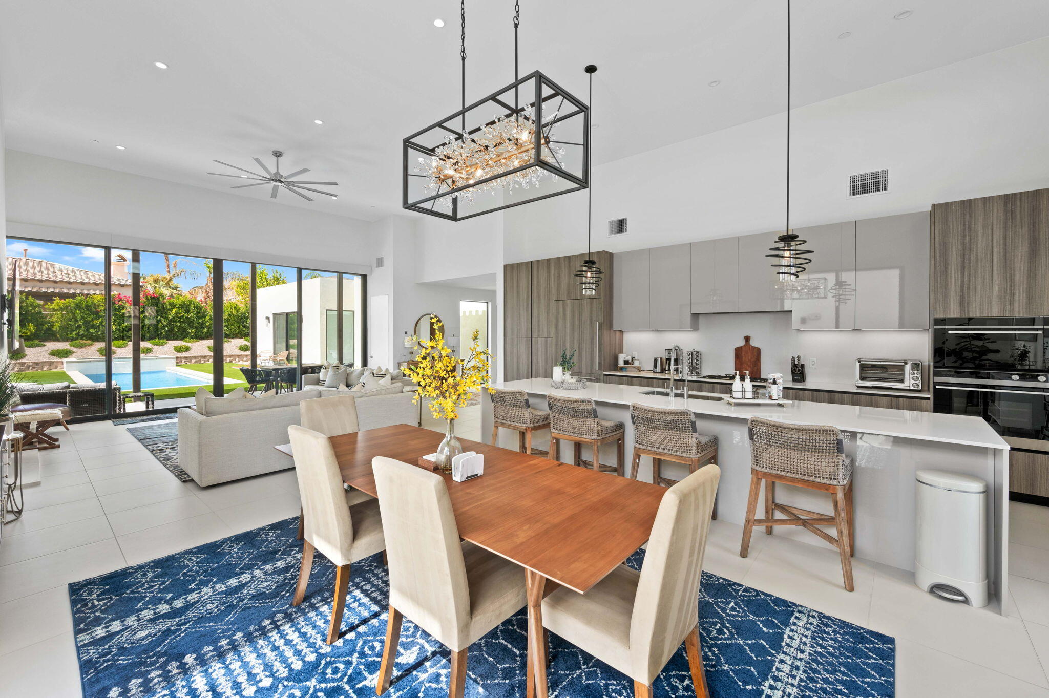 57627 Santo Thomas La Quinta, CA 92253 - Photo 10 of 37 a kitchen with a dining table chairs and white cabinets