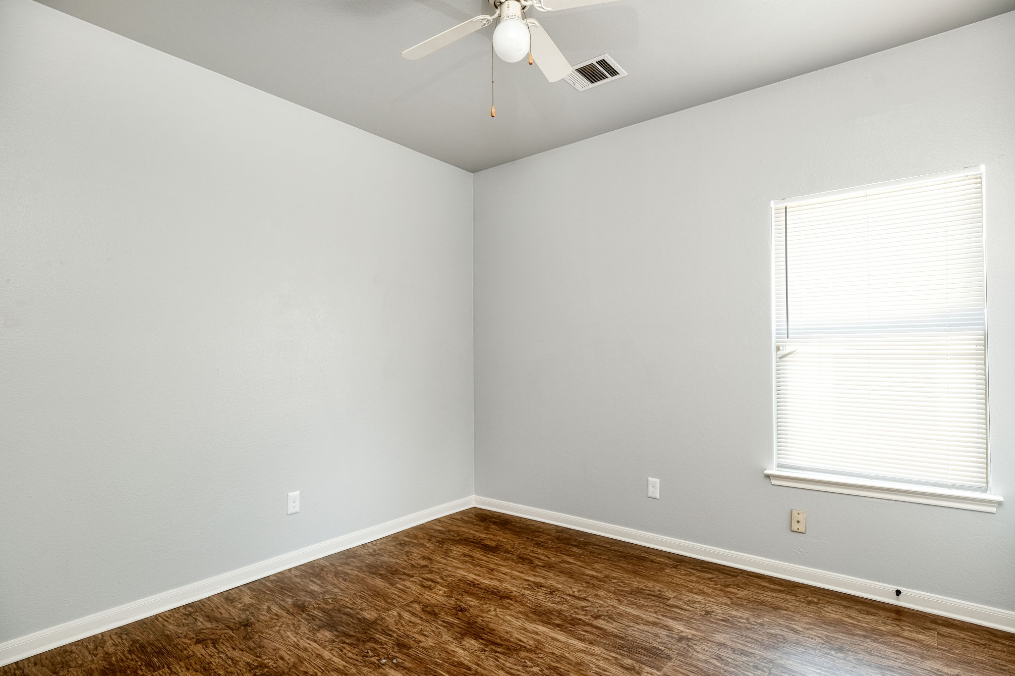 2802 Southampton Way, Unit A Round Rock, TX 78664 - Photo 11 of 13 Spare room featuring dark wood-style floors and a ceiling fan