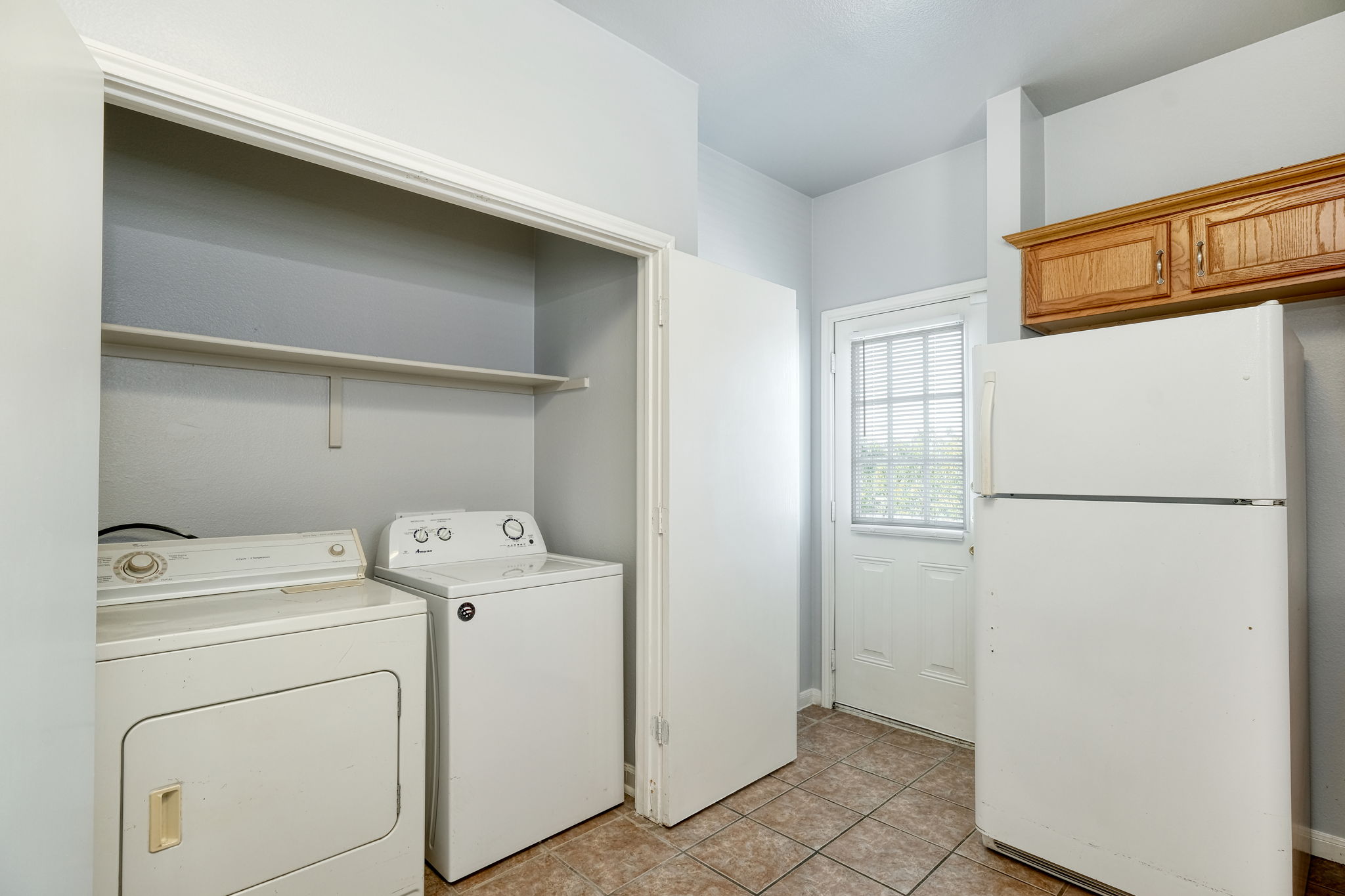 2802 Southampton Way, Unit A Round Rock, TX 78664 - Photo 6 of 13 Laundry area with washing machine and clothes dryer and light tile patterned floors