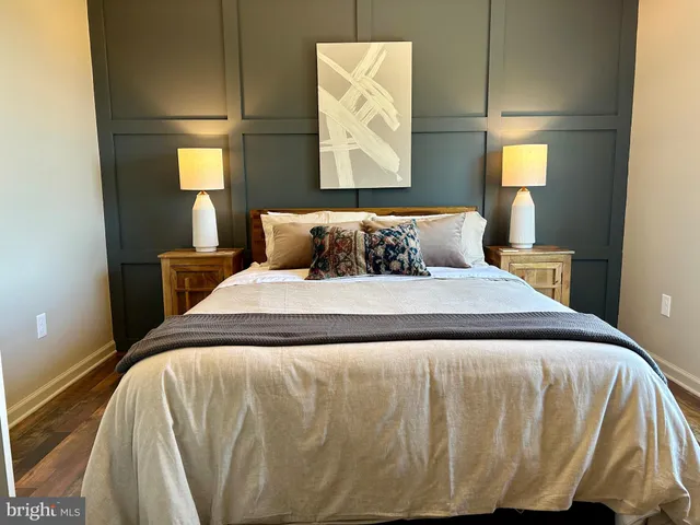 a bed sitting in a bedroom next to a lamp